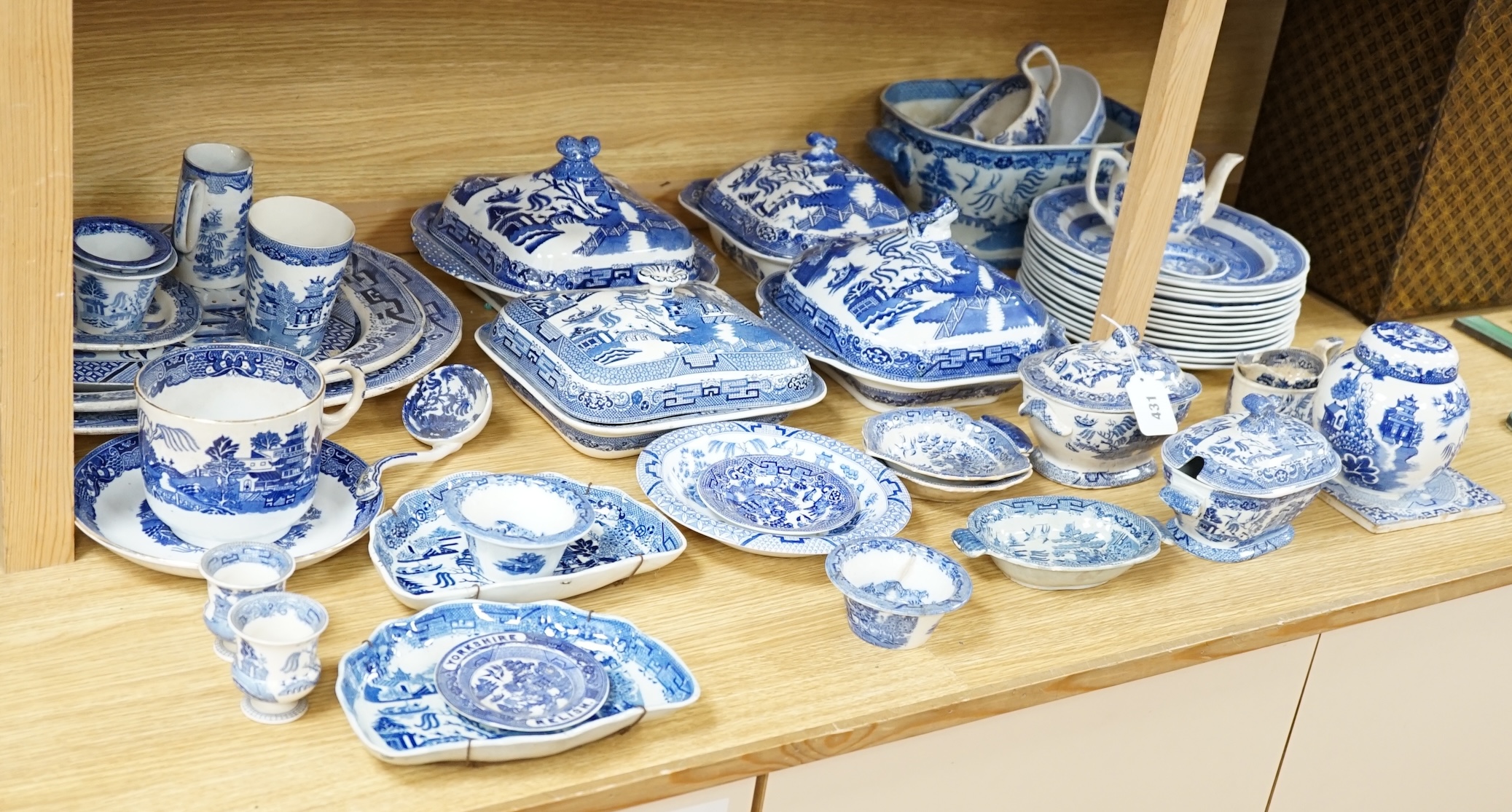 A mixed collection of Willow pattern blue and white dinnerware, including four tureens and covers, plates meat dishes etc. (large quantity). Condition - varied poor to fair to good